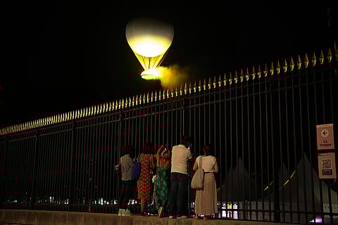 2024 Paralympics Opening Ceremony: People watch the cauldron with the Paralympic flame rise at the end of the Opening Ceremony